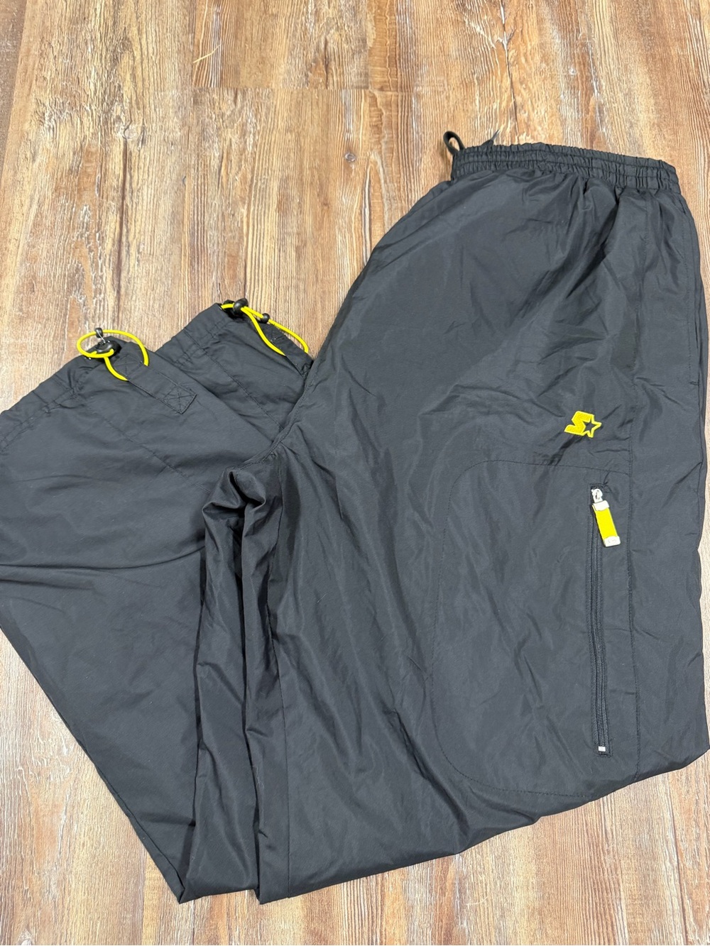 Vintage Starter black sweatpants with yellow accents, size XL